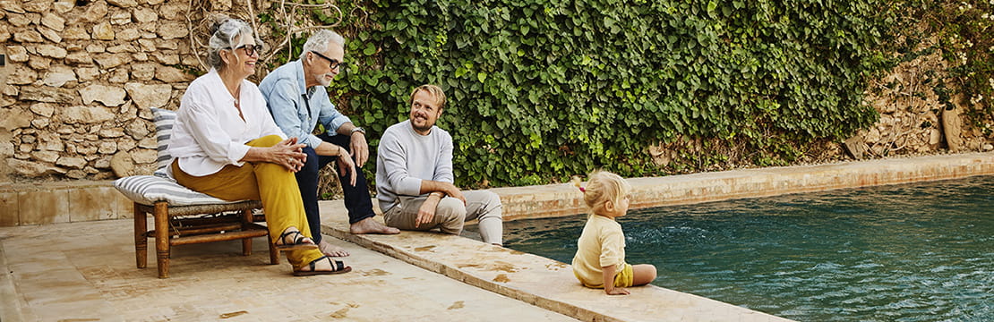 Family sitting by the poolside
